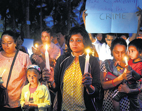 Parents and children at a candle light vigil from the Vibgyor High school premises to  Kundanahalli gate in Bangalore on Friday. DH Photo