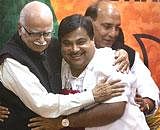 Senior BJP leader L K Advani hugs Nitin Gadkari after he was announced as the new party President during a press conference in New Delhi on Saturday. PTI