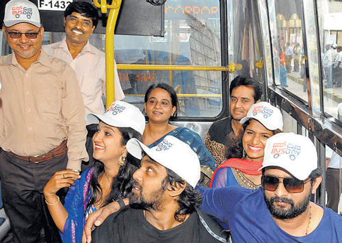 Actors Dhruva Sarja, Srinagara Kitti, Roopika, singer Shamitha Malnad, BMTCMDEkroop Caur and others travel by a bus in the City on Tuesday. DH PHOTO