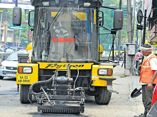 The self-propelled machine Python 5000 filling a pothole in the City. DH PHOTO