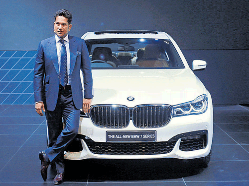 Legendary Indian cricketer Sachin Tendulkar poses with the BMW 7 series car during its launch at the Indian Auto Expo in Greater Noida on Thursday.  Reuters
