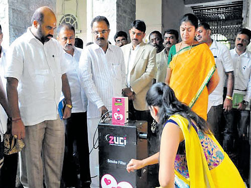 Nisha Nazre, founder of Zuci Fem Care Solutions, explains to BBMP officials how the incinerator disposes sanitary  napkins in a hygienic manner. DH photo