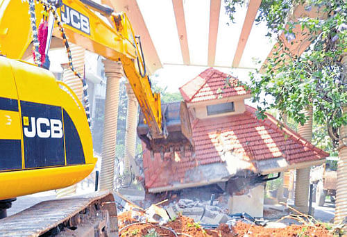 BBMP demolishes the entrance arch of Classic Orchards off  Bannerghatta Road on Friday.