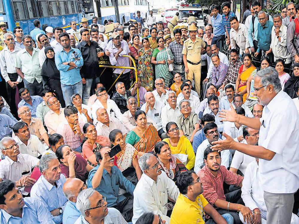MLA&#8200;S Suresh Kumar addresses protesters in front of the  BDA&#8200;office on Wednesday. dh photo