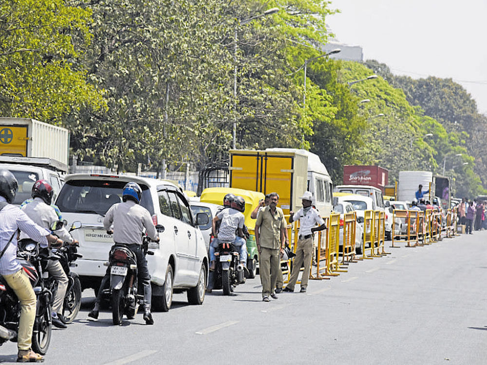 Traffic comes to a halt on Sheshadri Road as police segregate vehicles, allowing only BMTC buses and official cars to ply on Nrupatunga Road on Wednesday. DH photo