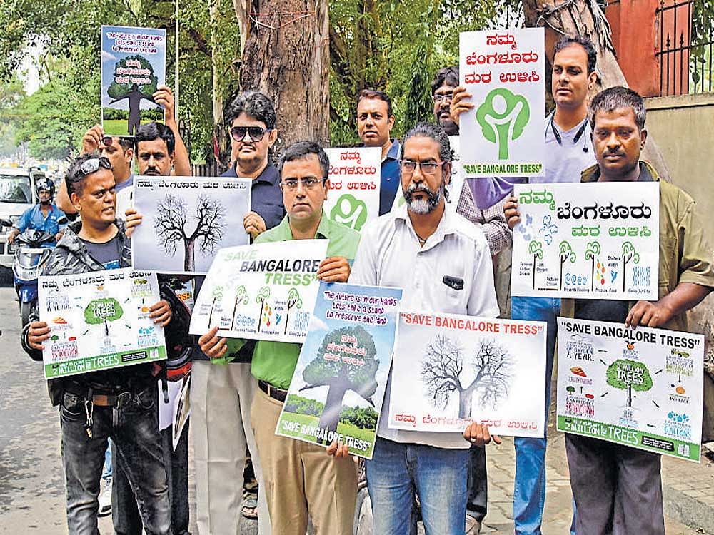 green warriors: Citizens, with the support of Children's Rights Initiative for Shared Parenting (CRISP) and other organisations, hold an awareness programme on saving trees, near Dairy Circle on Bannerghata Road on Saturday. dh Photo