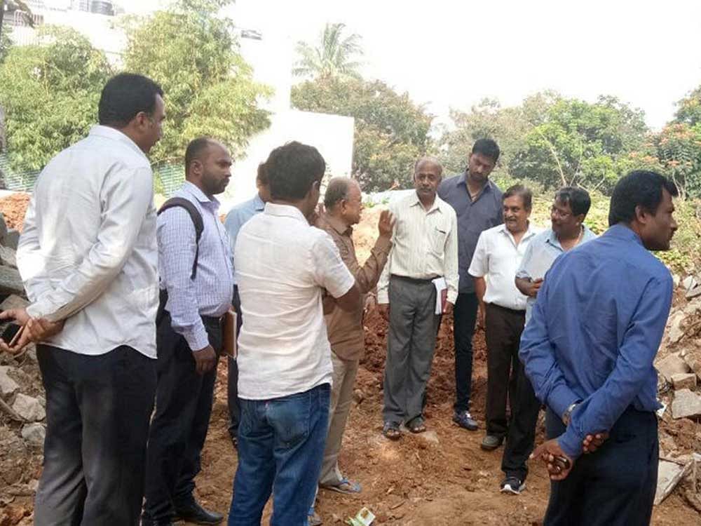BBMP Commissioner N Manjunath Prasad and other officials inspect the road dug up by GAIL in Sanjay, Nagar on Thursday.