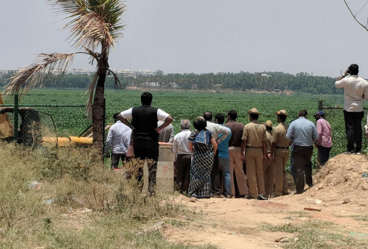 A team of BDA and NGT officials inspect the Bellandur Lake on Saturday.