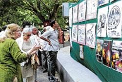 Participants looking at the posters depicting the effects of road widening at No to Irrational Road Widening Convention in Bangalore on Sunday. DH PHOTO