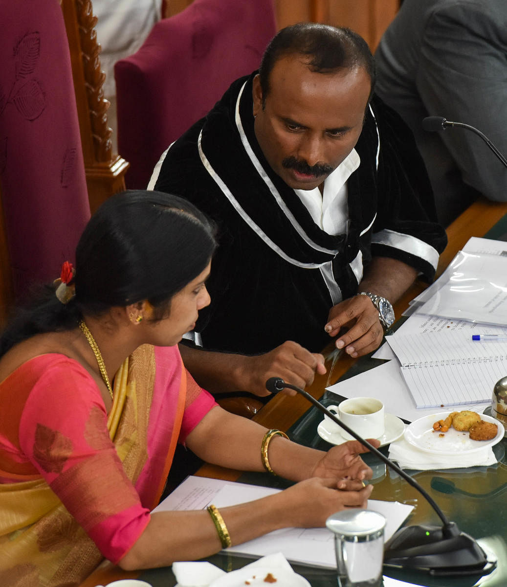 Mayor R Sampath Raj interacts with his deputy Padmavati atthe BBMP general meeting on Thursday. DH PHOTO