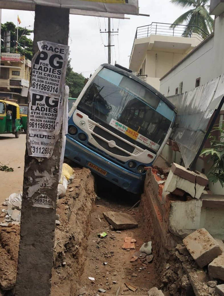 The BMTC bus that landed in an open drain in the Wilson Garden police station limits on Sunday morning. 