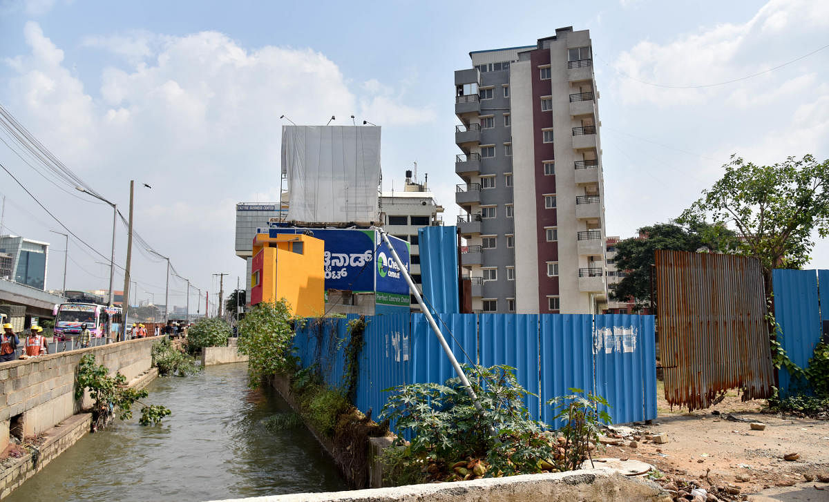 Many allottees say their sites are within touching distance of a stormwater drain (rajakaluve) that criss-crosses the sprawling residential colony, off Magadi Road in southwestern Bengaluru. (DH File Photo. For representation only)