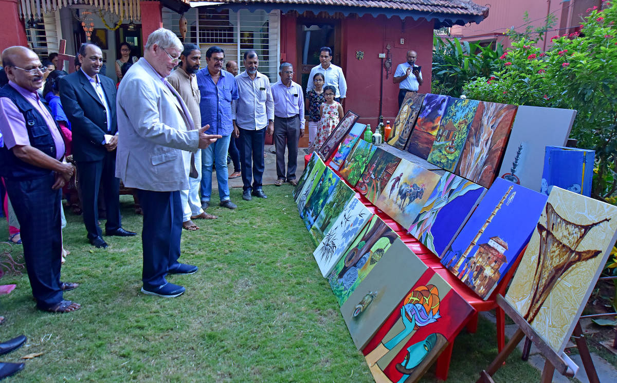 Dignitaries look at the paintings during the inauguration of Kadri Rocks, an art gallery, in Mangaluru. 