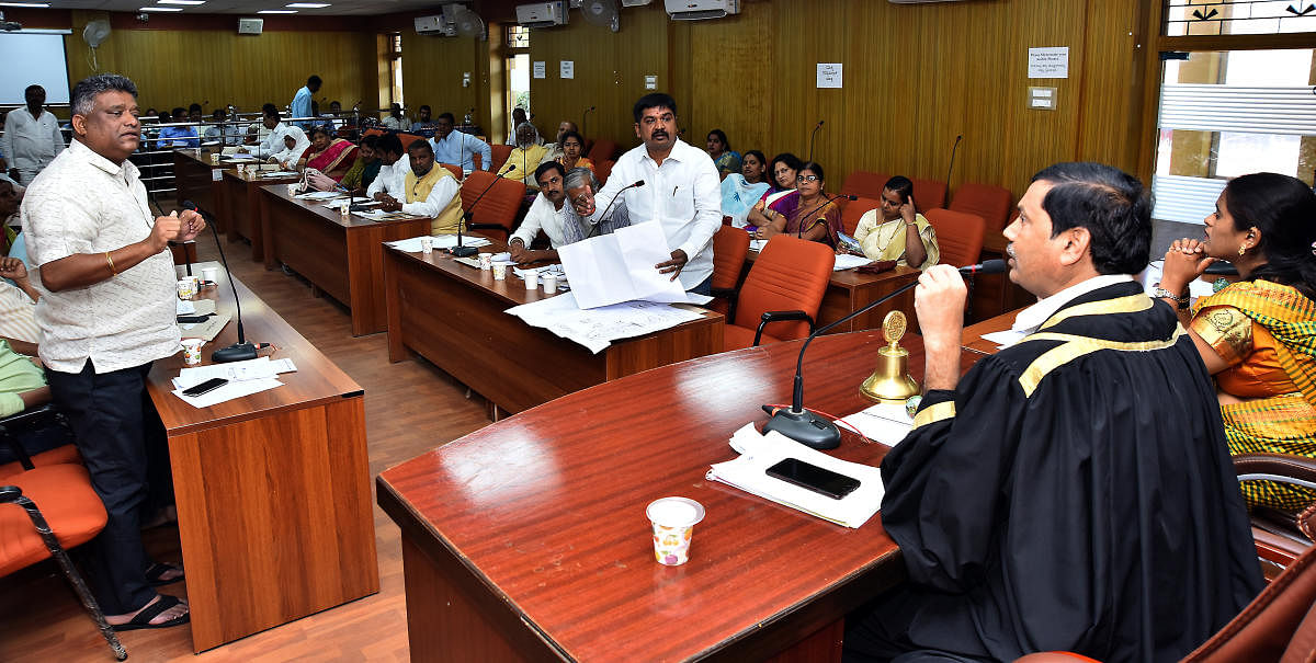 Corportators Veeranna Savadi and Ganesh Tagargunti in discussion with Mayor Sudhir Saraf, at the HDMP's general body meeting held in Hubballi on Thursday.
