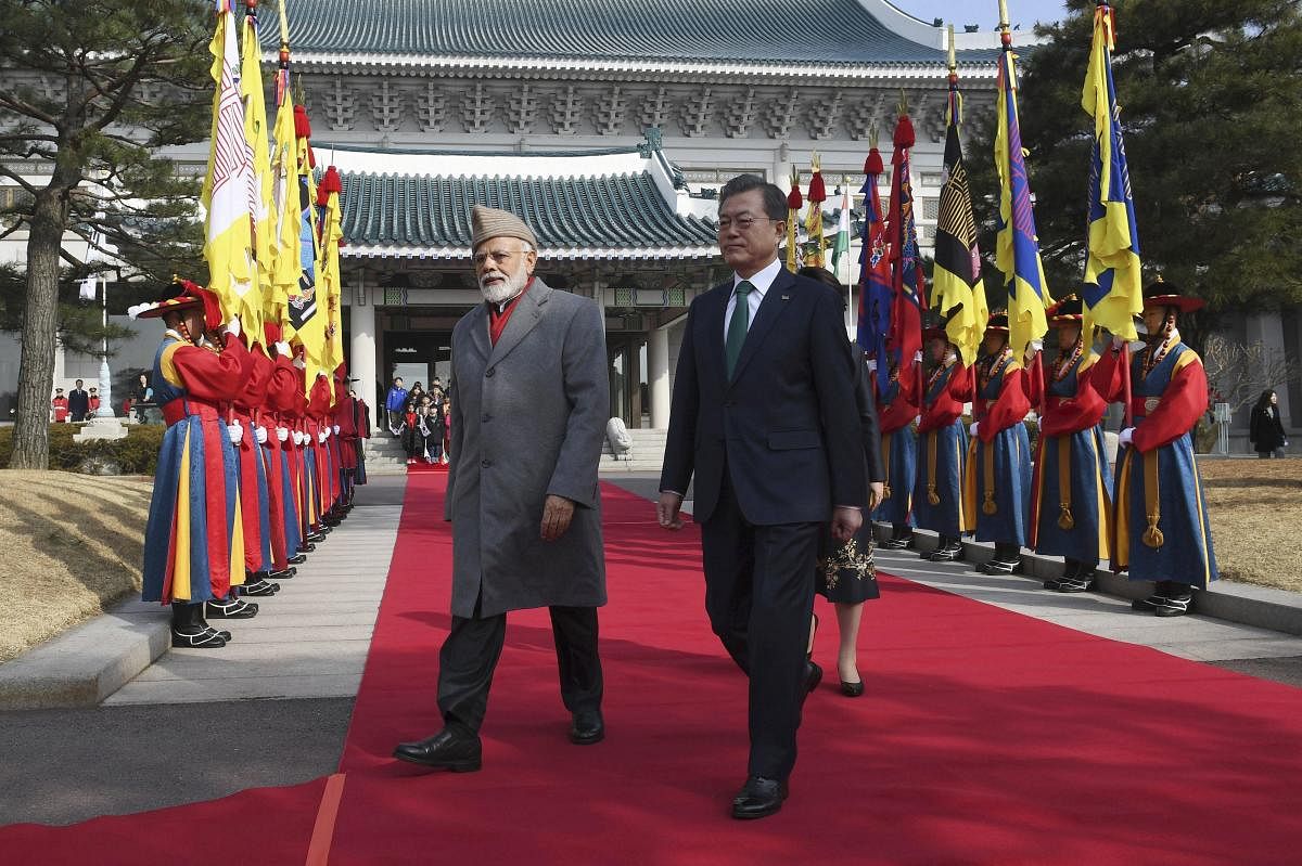 Indian Prime Minister Narendra Modi, left, and South Korea's President Moon Jae-in review honor guards during a welcoming ceremony at the presidential Blue House in Seoul Friday, Feb. 22, 2019. Modi is on a two-day visit to South Korea as part of an effor