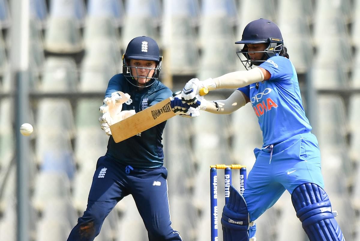 England's wicketkeeper Sarah Taylor (L) watches India's captain Mithali Raj play a shot during the first match of the women's one-day international (ODI) cricket series between India and England at the Wankhede Stadium in Mumbai on February 22, 2019. (AFP
