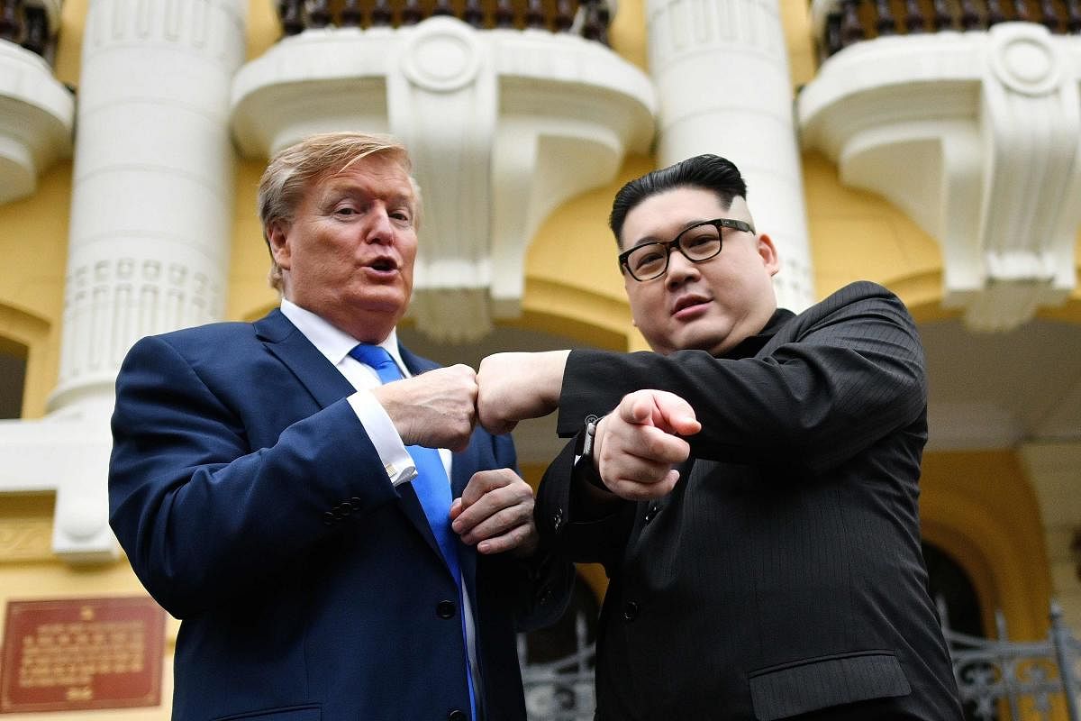US President Donald Trump impersonator Russel White (L) and North Korean leader Kim Jong Un impersonator Howard X (R) pose together for photographs outside the Opera House in Hanoi on February 22, 2019. (AFP)