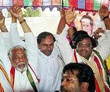 TRS President K. Chandra Sekhar Rao raises hands with Congress legislators staging indefinite hunger strike demanding withdrawal of cases registered against students who participated in the Telangana movement, in Hyderabad on Tuesday. PTI