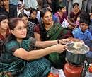 TRS MP Vijayashanthi tries her hand in cooking during 'Hyderabad Cooks on Roads' agitation by Telangana activists in support of Telangana statehood, in Hyderabad on Sunday. PTI