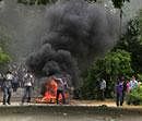 Indian students throw stones at policemen near burning tires during a two-day strike demanding the creation of a new state of Telangana, at Osmania University in Hyderabad, India, Tuesday, July 5, 2011. The strike came after more than a dozen lawmakers resigned from Parliament to press their demand that the new state of Telangana be carved from Andhra Pradesh.  AP Photo