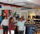 Power learn: Bescom officials inspect power usage at a shop on Church Street on Friday. DH Photo
