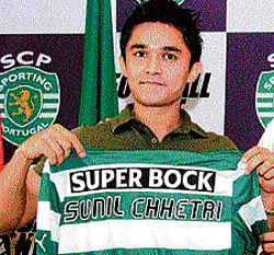 milestone moment: Sunil Chhetri poses with his Sporting Lisbon jersey in New Delhi on Thursday. AFP