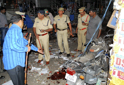 Hyderabad: Experts search for clues at the site of a bomb blast in Hyderabad on Thursday. PTI Photo