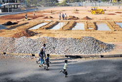 cause of concern Children jog at the Jayanagar stadium amidst construction activity by the KSCA to set up a cricketing facility. DH photo