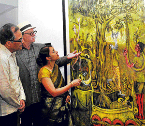 Collector Waswo (Centre), curator Lina Vincent Sunish and Sudhakar Rao, president of the advisory committee of the National Gallery of Modern Art (NGMA), take a look at a work at an  exhibition of Indian Printmaking at the NGMA in the City on Saturday. DH Photo