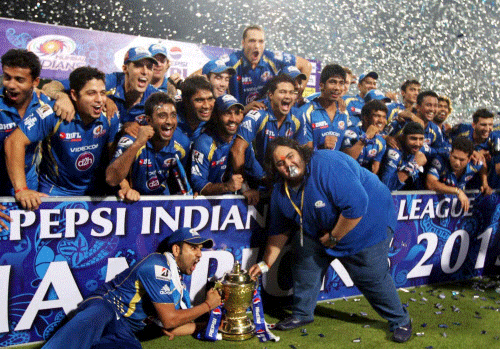 Mumbai Indians owner Neeta Ambani's son Hari Anant poses with winners trophy and members of team during IPL 6 Final Match at Eden Garden in Kolkata on Sunday. PTI Photo