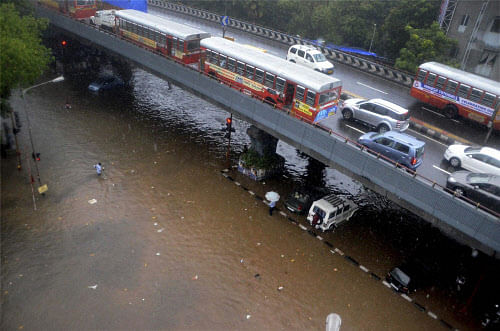A view of flooded roads under a fly-over during pre- monsoon showers in Mumbai on Monday. PTI Photo