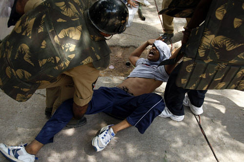 Indian policemen detain a supporter of creation of a separate state of Telangana from the current southern Indian state of Andhra Pradesh, during a demonstration in Hyderabad, India, Saturday, Sept. 7, 2013. A 24-hour strike has been called by pro-Telangana groups as a stand against those opposed to the proposed bifurcation of the State. (AP Photo