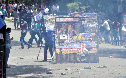 Police firing teargas shells to stop pro-Telangana students of Osmania University who were protesting against the Seemandhra activists in Hyderabad on Saturday. PTI Photo