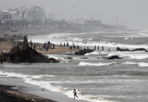 A boy runs on the seashore in Visakhapatnam, in the southern Indian state of Andhra Pradesh, Thursday, Nov. 28, 2013. Cyclonic storm 'Lehar' which was expected to cause extensive damage in coastal Andhra Pradesh, weakened into a deep depression Thursday, according to a news agency. AP Photo