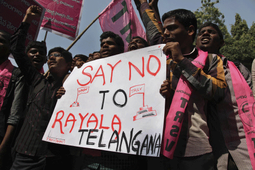 Student supporters of Telanagana Rashtra Samathi (TRS) shout slogans during a protest in Hyderabad, India, Wednesday, Dec. 4, 2013. Earlier this year India's ruling coalition endorsed the creation of a 29th state called Telangana carved out of existing Andhra Pradesh state. The TRS has called for a shutdown strike Thursday in the Telangana region to protest a recent proposal to add two more states to the proposed state. AP photo