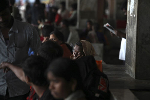 Passengers wait at a bus terminal after transporation was disrupted following the shut down,Transport services were paralysed as over 12,000 buses of state-owned Andhra Pradesh State Road Transport Corporation (APSRTC) went off the roads in Seemandhra, as the two regions are together known. AP photo
