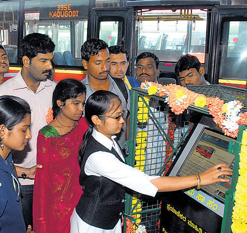 Commuters use a BMTC passenger information kiosk, which was inaugurated in the City on Saturday. DH Photo