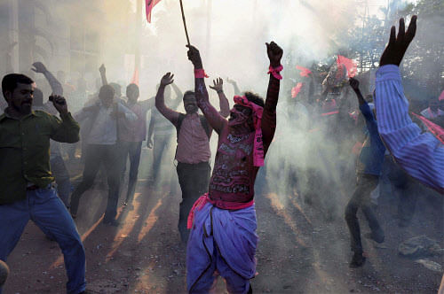 TRS supporters dance as they celebrate the passage of Telangana bill in the Lok Sabha, in Hyderabad on Tuesday. PTI Photo