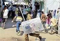 The Big Stick: Police chase away protesters during a strike in Hyderabad on Monday. AP