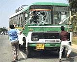 A bus being damaged by men protesting against the seperation of Telangana from Andhra Pradesh in Ralyalseema on Thursday. PTI