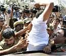 Security men detain a protester in Hyderabad. PTI