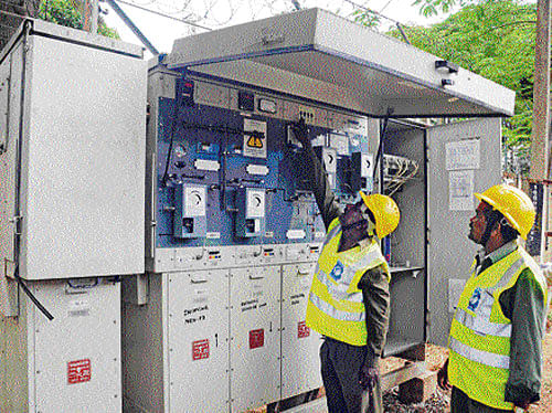 'power'ful: Bescom workers operate the Distribution Automation Service Station at  Peenya Industrial area on Friday. dh Photo