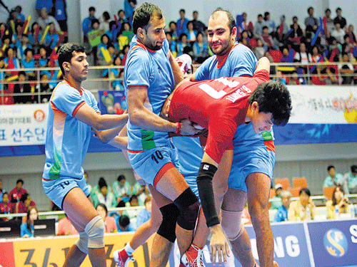 Indians catch Thailand's Santi Bunchoet during their kabbadi match at the Asian Games on Monday. India won 66-27. AP