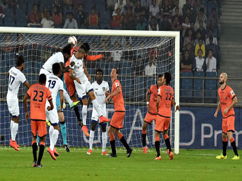 Chennaiyin FC player (white) and Delhi Dynamos FC players in action during their Indian Super League 2014 match in New Delhi. PTI photo