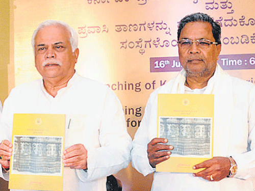 Karnataka Chief Minister Siddaramaiah (Right) releases the Tourism Policy 2015-20 in Bengaluru on Thursday. DH Photo