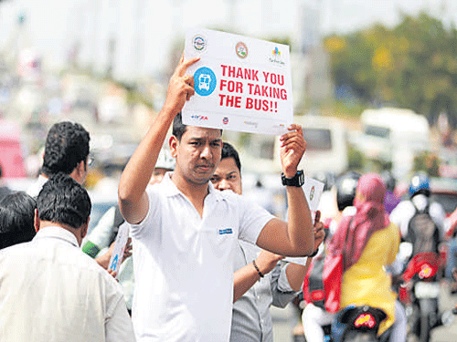 Volunteers promote Car Free initiative on Thursday. DH Photo
