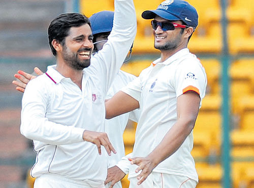 SPINNING TROUBLE DY Patil Academy's Iqbal Abdulla (left) celebrates a wicket with his team-mate on Friday. DH PHOTO