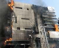 In this handout photo released by the GVK Emergency Management and Research Institute (EMRI), the Park Superspeciality Hospital is seen on fire in Hyderabad on Tuesday. AP