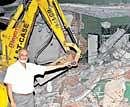 KSCA secretary Brijesh Patel shows the tennis court demolished by the BMRCL at the Chinnaswamy Stadium in  Bangalore on Saturday. DH photo