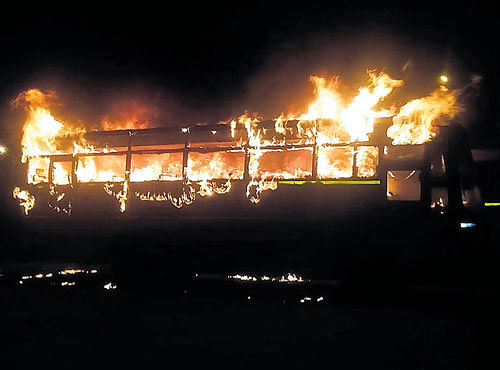 One of the buses on fire at the KSRTC depot on Mysuru Road on Thursday. DH PHOTO